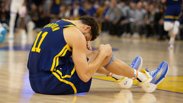 Warriors’ Klay Thompson sits on the floor.